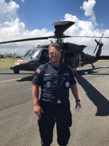 Dr. Schobitz in front of the Blackhawk helicopter