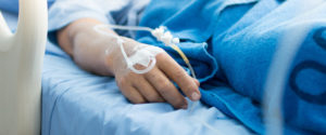 patient with IV in hand