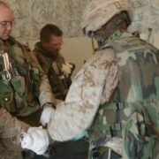 Soldier assisting another soldier